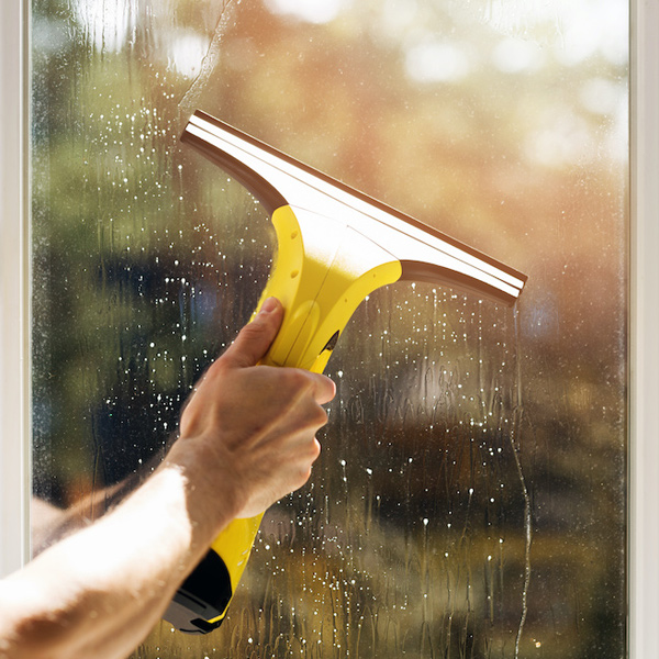 window cleaning professional cleaning window with yeallow squeegee